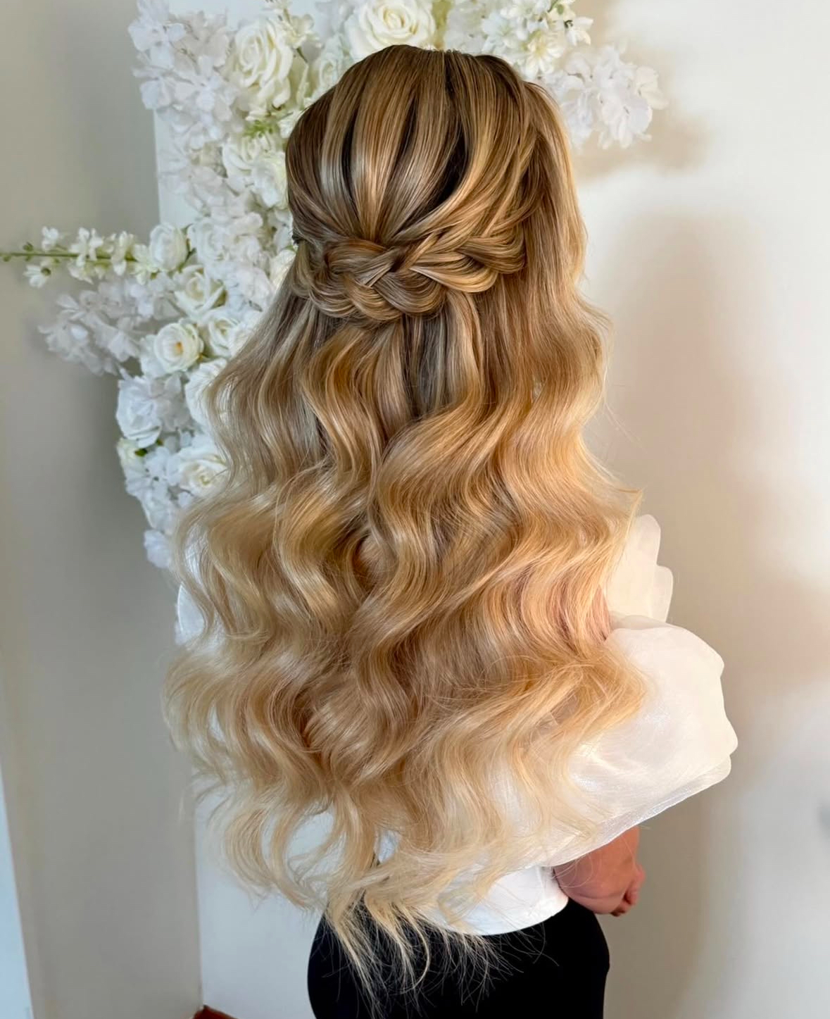 half up half down with braid on long blonde hair with dimension and volume